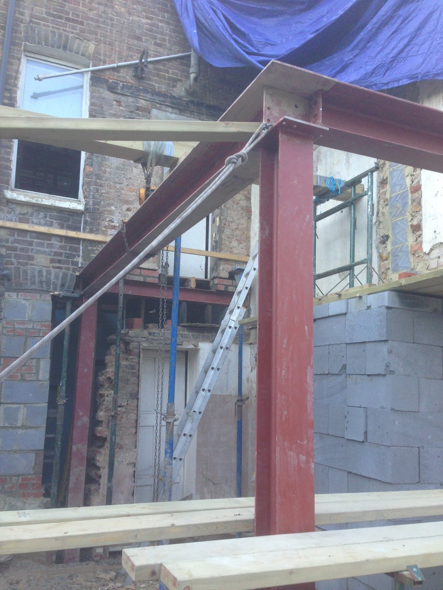 Close-up of a structural steel beam and column supporting the extension