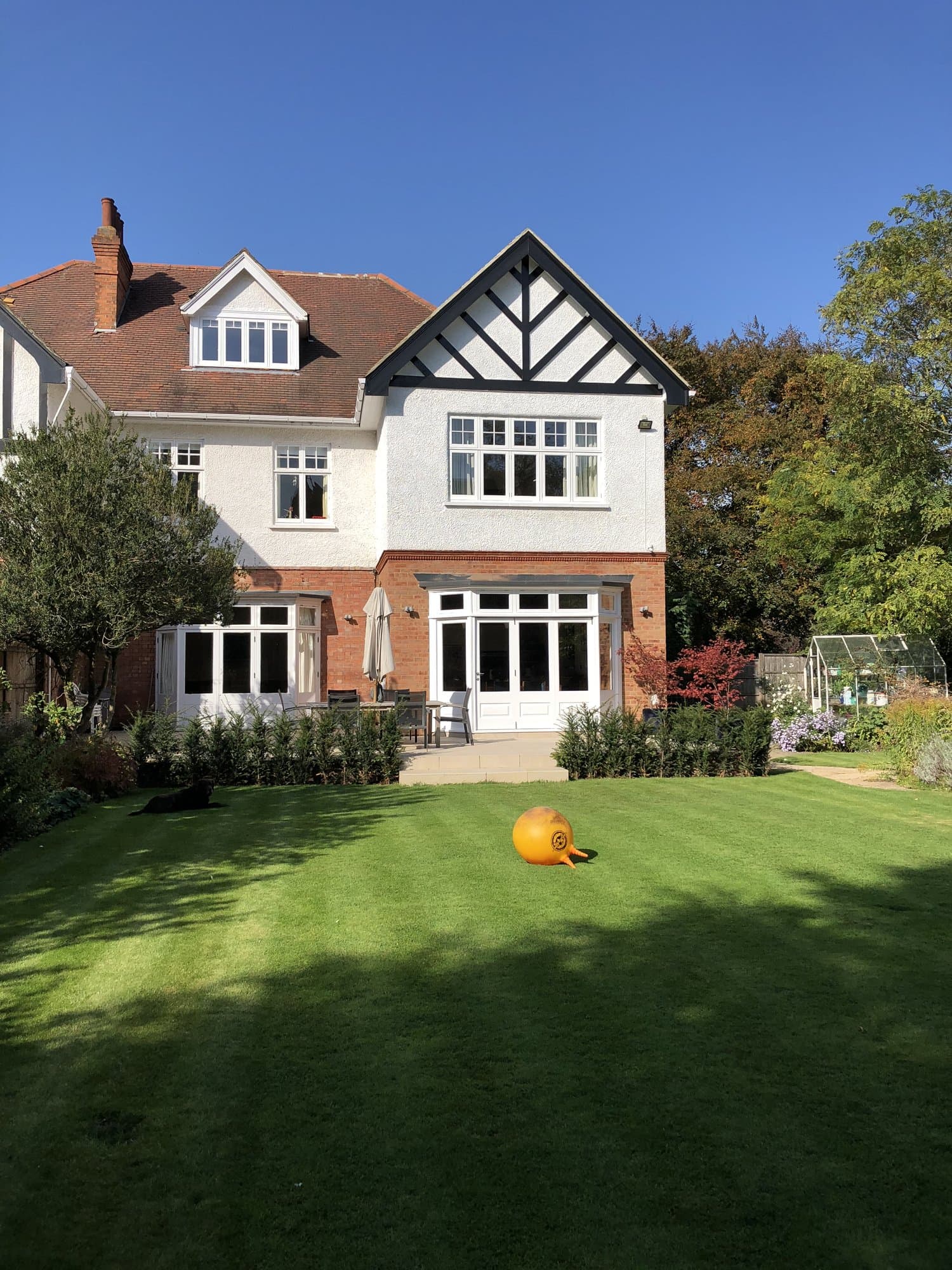 Completed Tudor-style wing extension in Hampstead under a clear blue sky